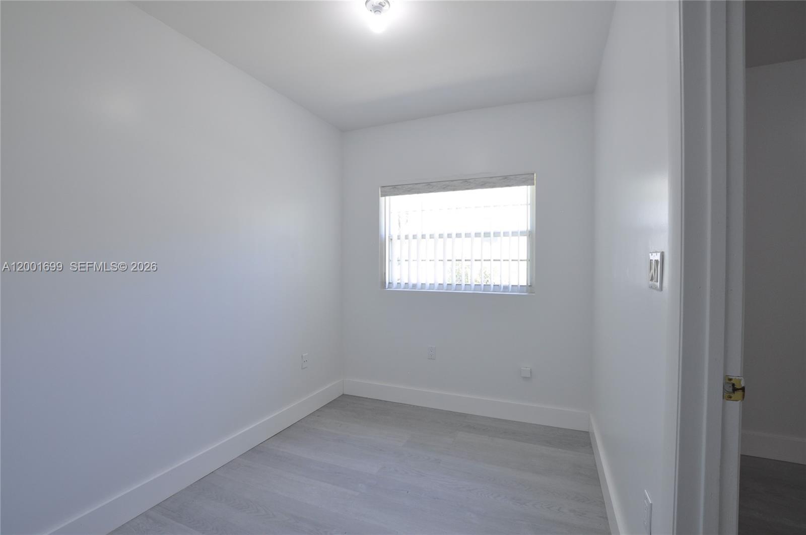 11111 Southwest 78th Court Pinecrest, FL 33156 - Photo 12 of 19 an empty room with a window