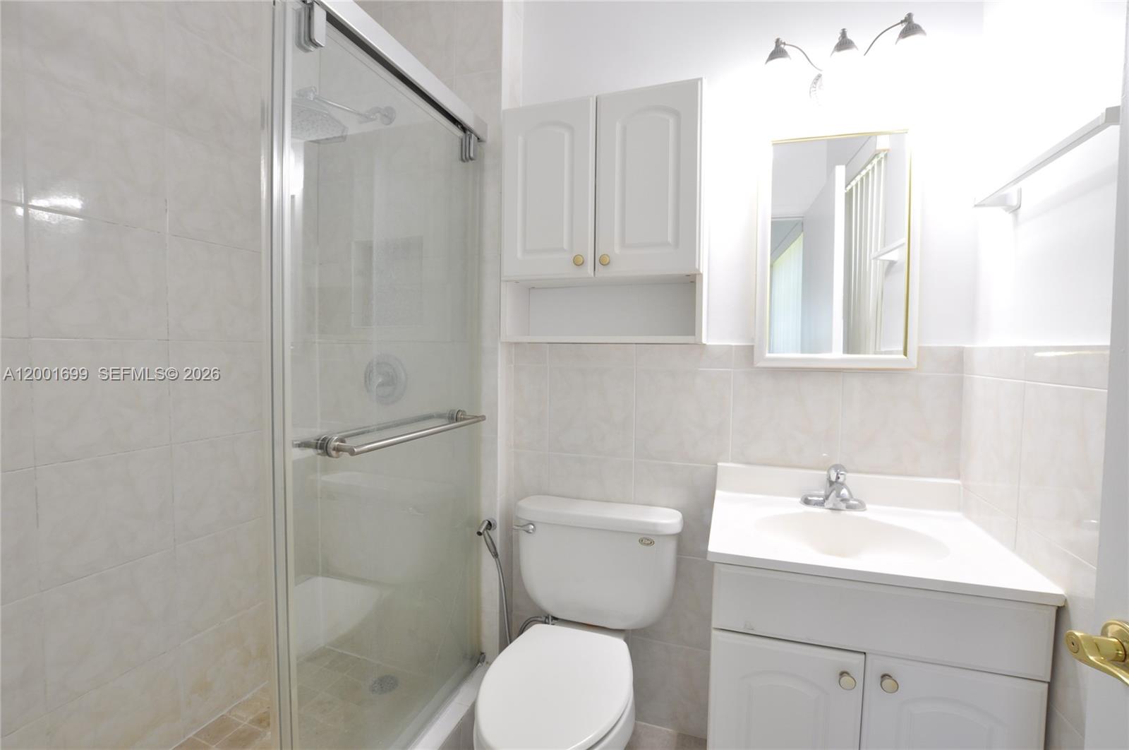11111 Southwest 78th Court Pinecrest, FL 33156 - Photo 15 of 19 a bathroom with a toilet sink and shower
