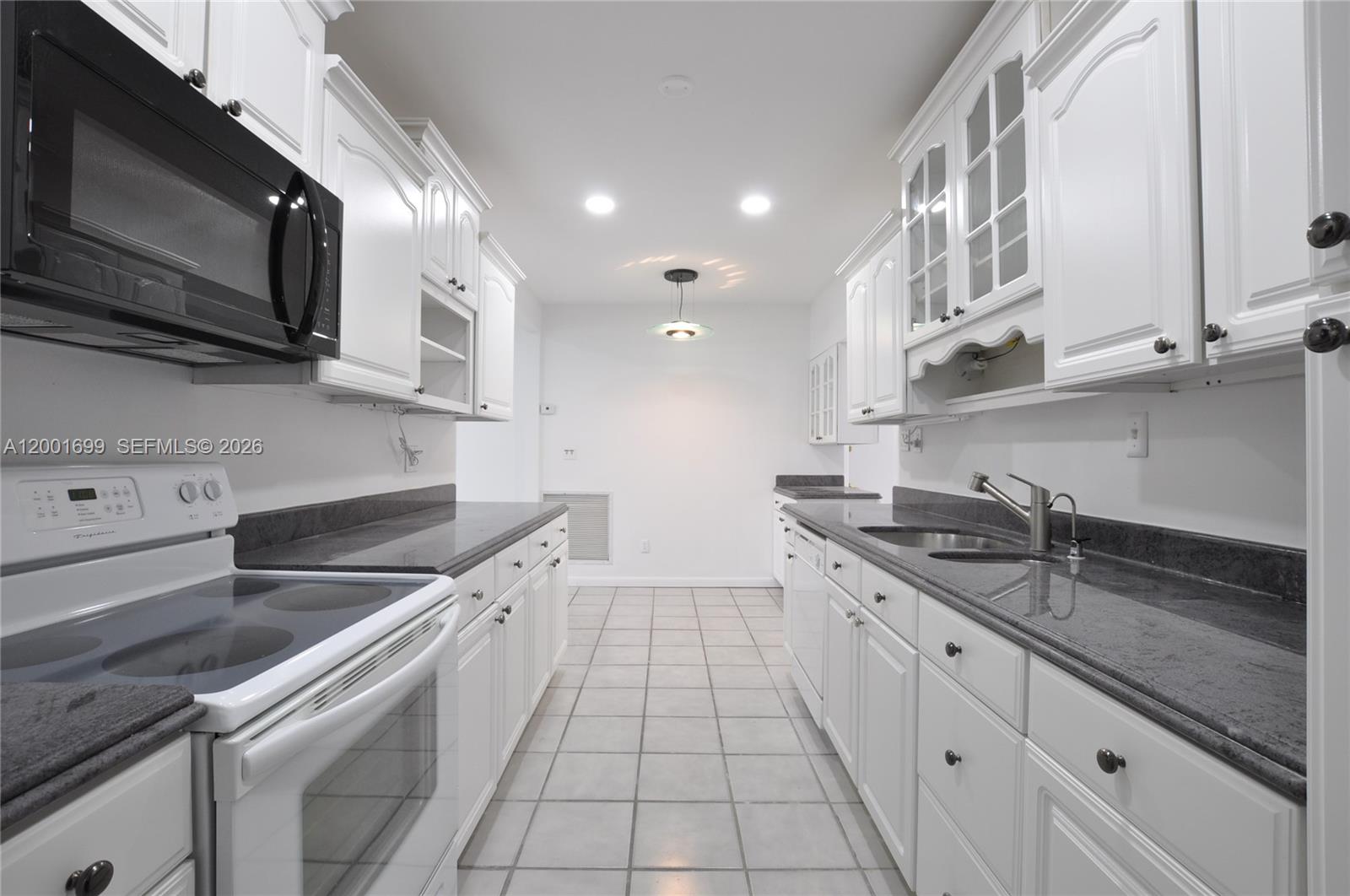 11111 Southwest 78th Court Pinecrest, FL 33156 - Photo 9 of 19 a kitchen with stainless steel appliances granite countertop a sink and a stove