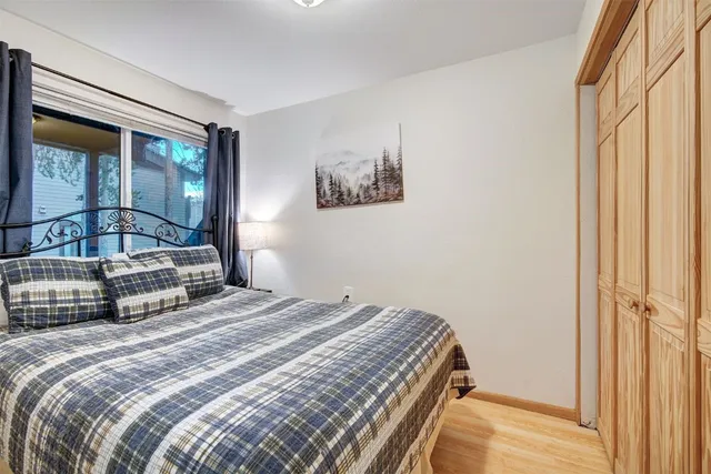 a bedroom with a bed and a large window