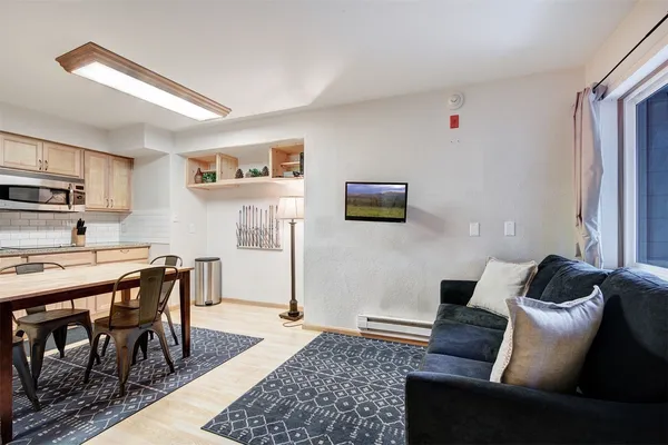 a living room with a couch and a rug