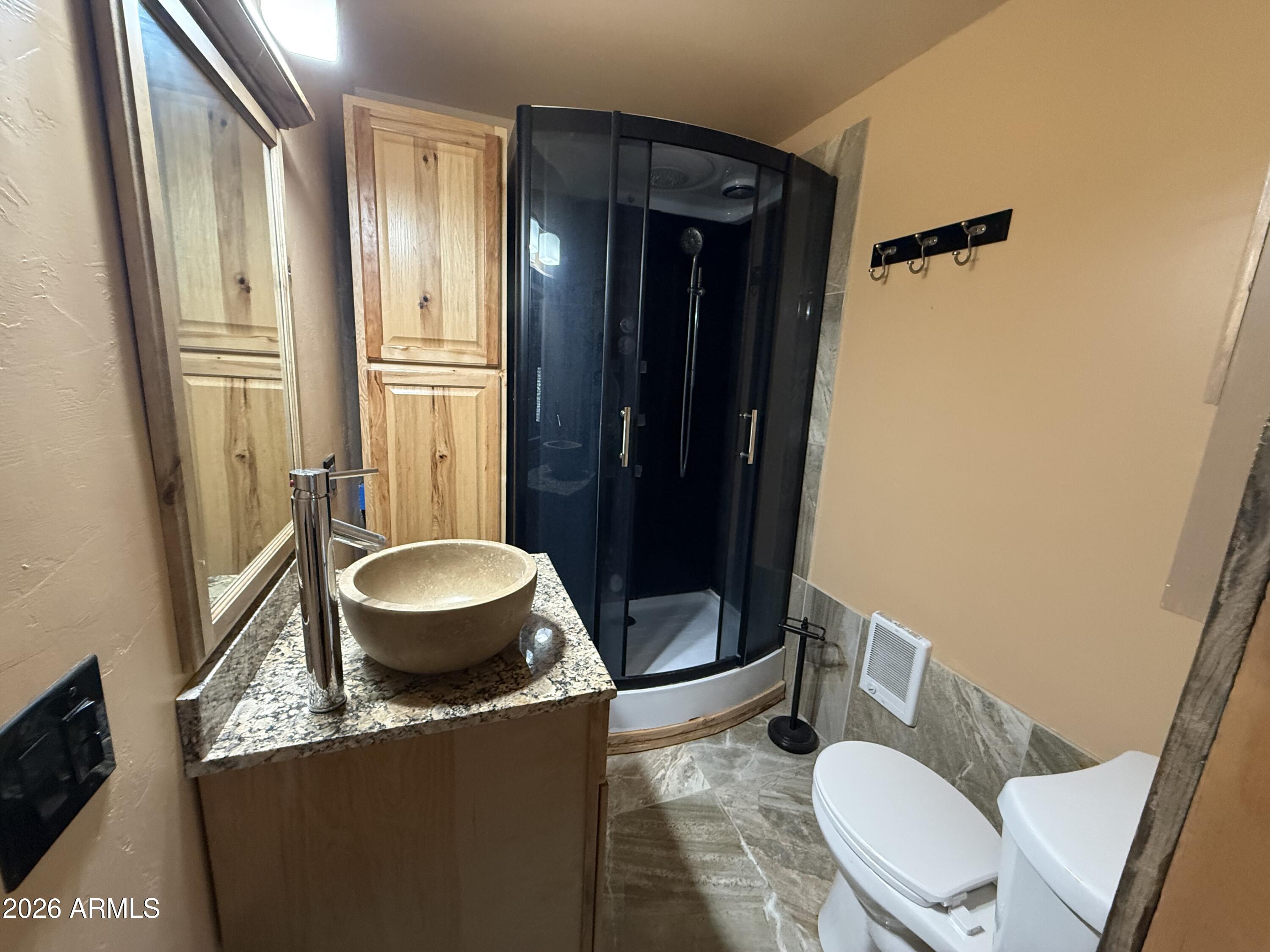 23338 Sunny South Road Crown King, AZ 86343 - Photo 12 of 32 a bathroom with a granite countertop toilet sink and mirror
