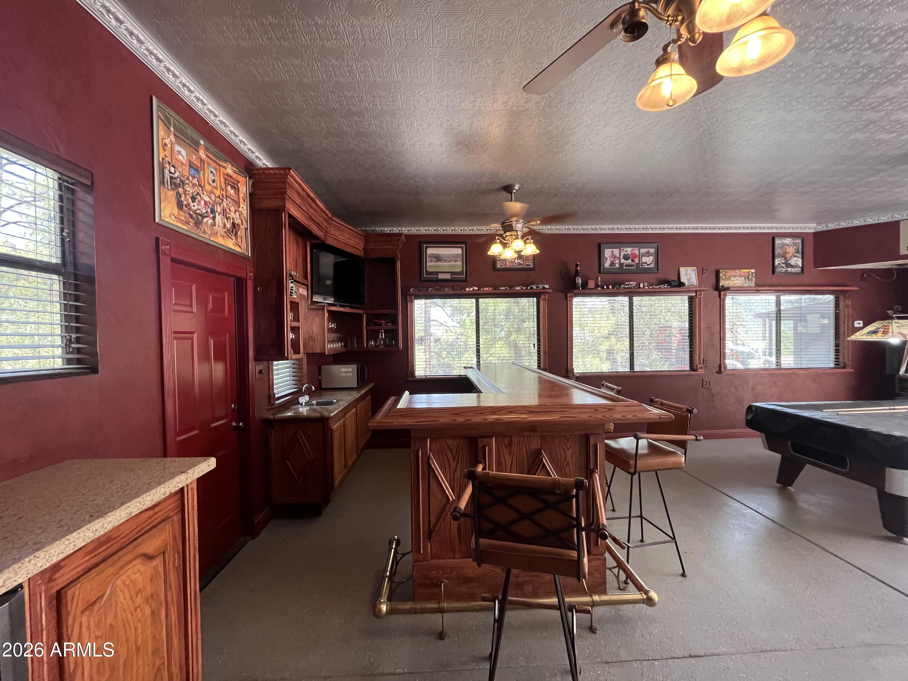23338 Sunny South Road Crown King, AZ 86343 - Photo 24 of 32 a view of a dining room with furniture and chandelier