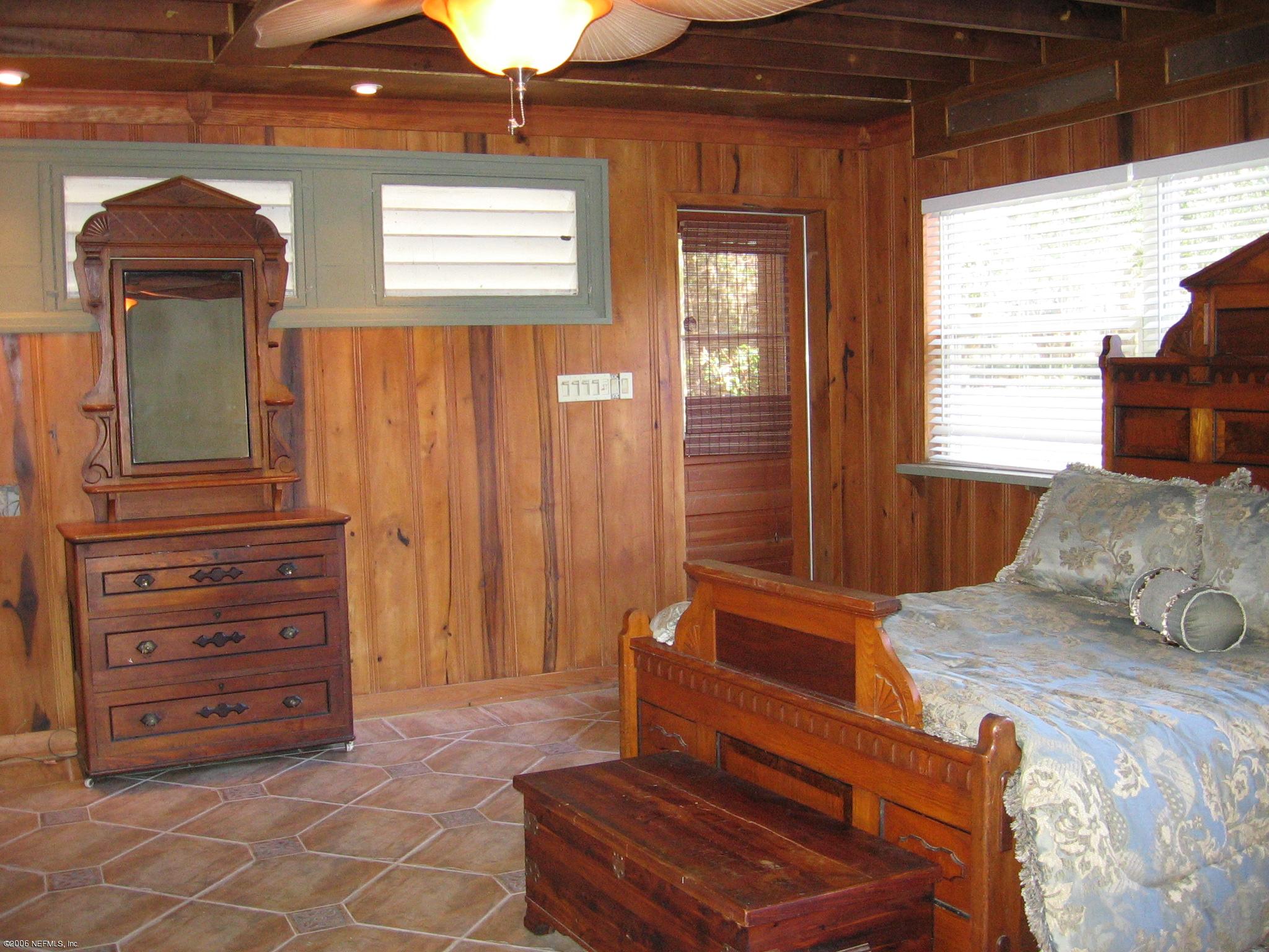 2728 Holly Point Road East Orange Park, FL 32073 - Photo 14 of 15 a bedroom with a bed and a dresser