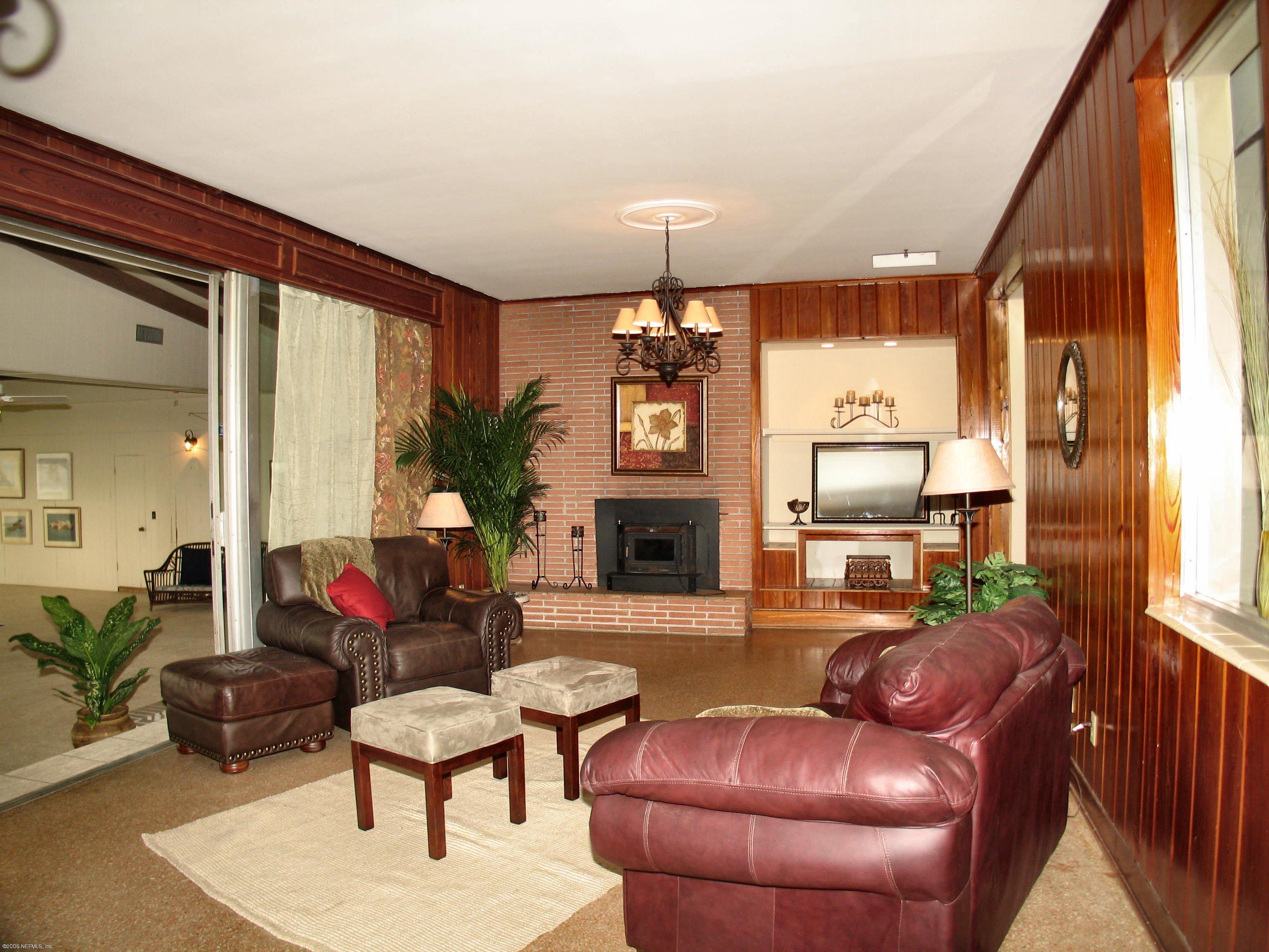 2728 Holly Point Road East Orange Park, FL 32073 - Photo 9 of 15 a living room with furniture fireplace and window