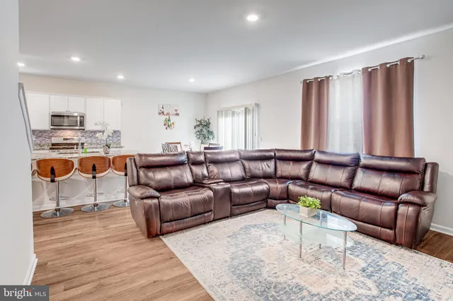 a bedroom with a bed a mirror and a window