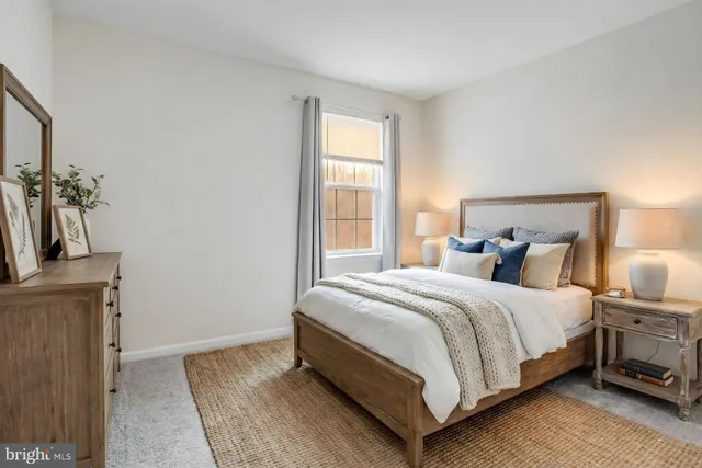 a bathroom with a granite countertop sink and a window
