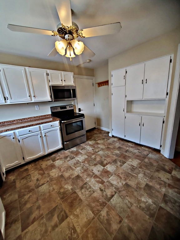 8 Ashland Street, Unit 1L Worcester, MA 01609 - Photo 14 of 27 a kitchen with granite countertop a stove a sink and a refrigerator
