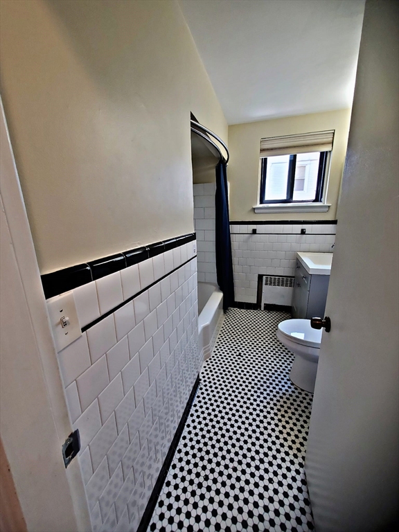 8 Ashland Street, Unit 1L Worcester, MA 01609 - Photo 15 of 27 a bathroom with a sink a toilet a window and vanity