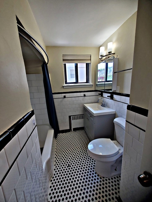 8 Ashland Street, Unit 1L Worcester, MA 01609 - Photo 16 of 27 a bathroom with a toilet a sink and a mirror