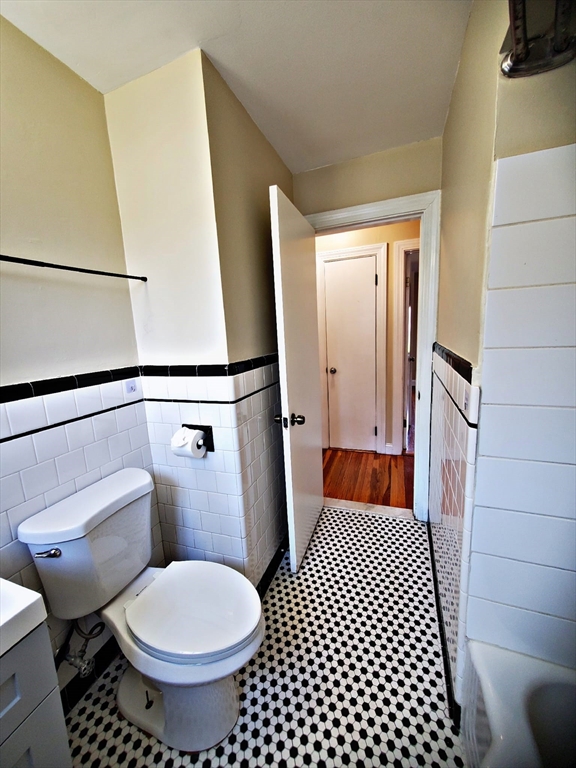 8 Ashland Street, Unit 1L Worcester, MA 01609 - Photo 17 of 27 a bathroom with a toilet and a mirror