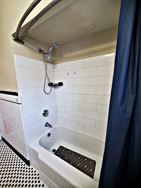 8 Ashland Street, Unit 1L Worcester, MA 01609 - Photo 18 of 27 a bathroom with a shower and a bathtub