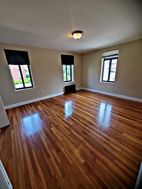 8 Ashland Street, Unit 1L Worcester, MA 01609 - Photo 20 of 27 wooden floor in an empty room with a window