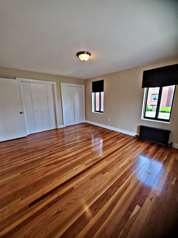 8 Ashland Street, Unit 1L Worcester, MA 01609 - Photo 21 of 27 a bedroom with a bed and a flat screen tv