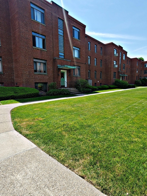 8 Ashland Street, Unit 1L Worcester, MA 01609 - Photo 3 of 27 a view of a building next to a big yard