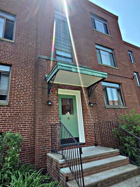 8 Ashland Street, Unit 1L Worcester, MA 01609 - Photo 4 of 27 a view of a brick house with a small yard