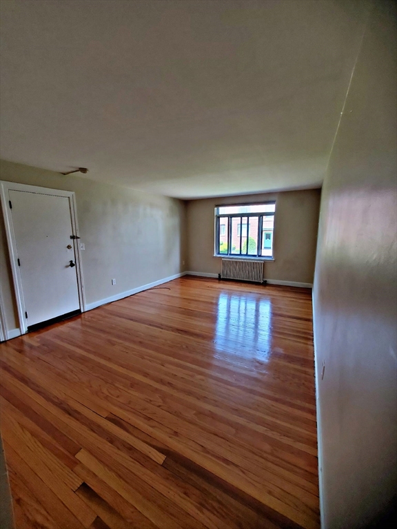 8 Ashland Street, Unit 1L Worcester, MA 01609 - Photo 6 of 27 a big room with wooden floor and windows
