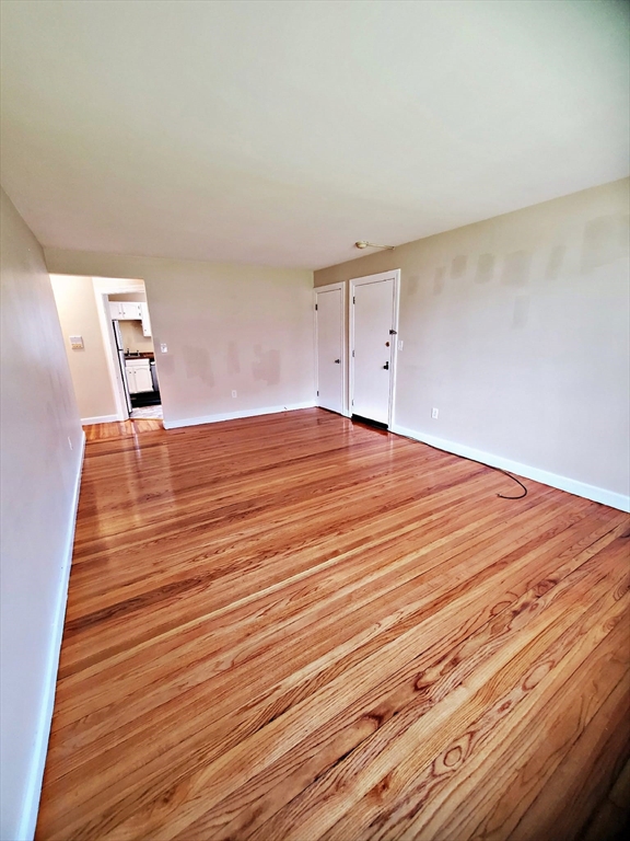 8 Ashland Street, Unit 1L Worcester, MA 01609 - Photo 8 of 27 a view of empty room with wooden floor