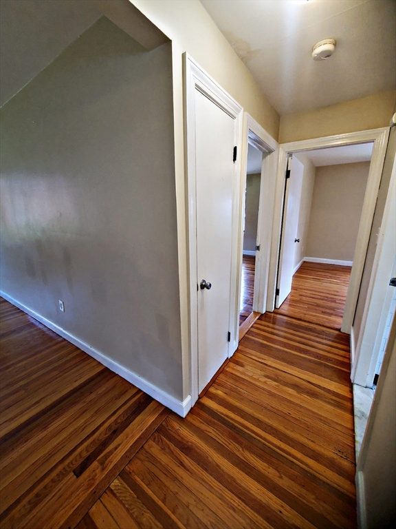 8 Ashland Street, Unit 1L Worcester, MA 01609 - Photo 9 of 27 a view of a hallway with wooden floor and staircase