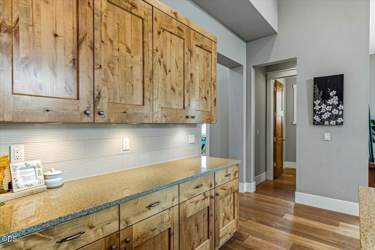 61333 Kindle Rock Loop Bend, OR 97702 - Photo 23 of 53 a kitchen with stainless steel appliances granite countertop a sink a stove and a refrigerator with wooden floor