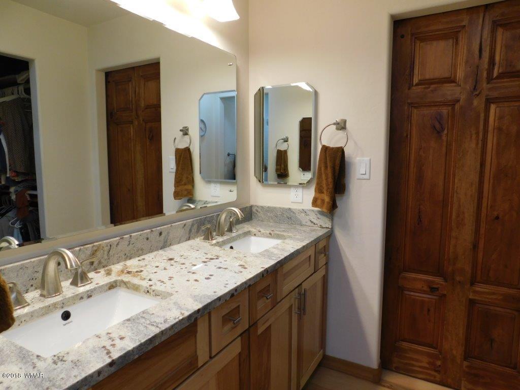 1941 Rim View Lane Heber, AZ 85928 - Photo 25 of 41 a bathroom with a granite countertop sink and a mirror