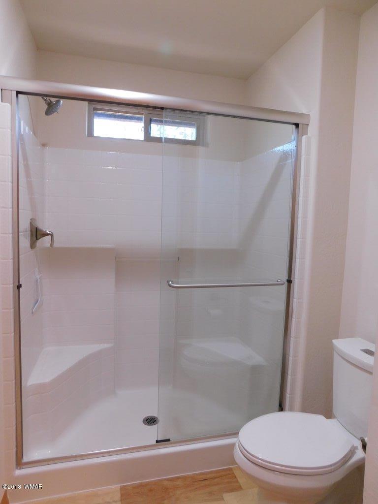 1941 Rim View Lane Heber, AZ 85928 - Photo 26 of 41 a bathroom with a shower a toilet and a shower