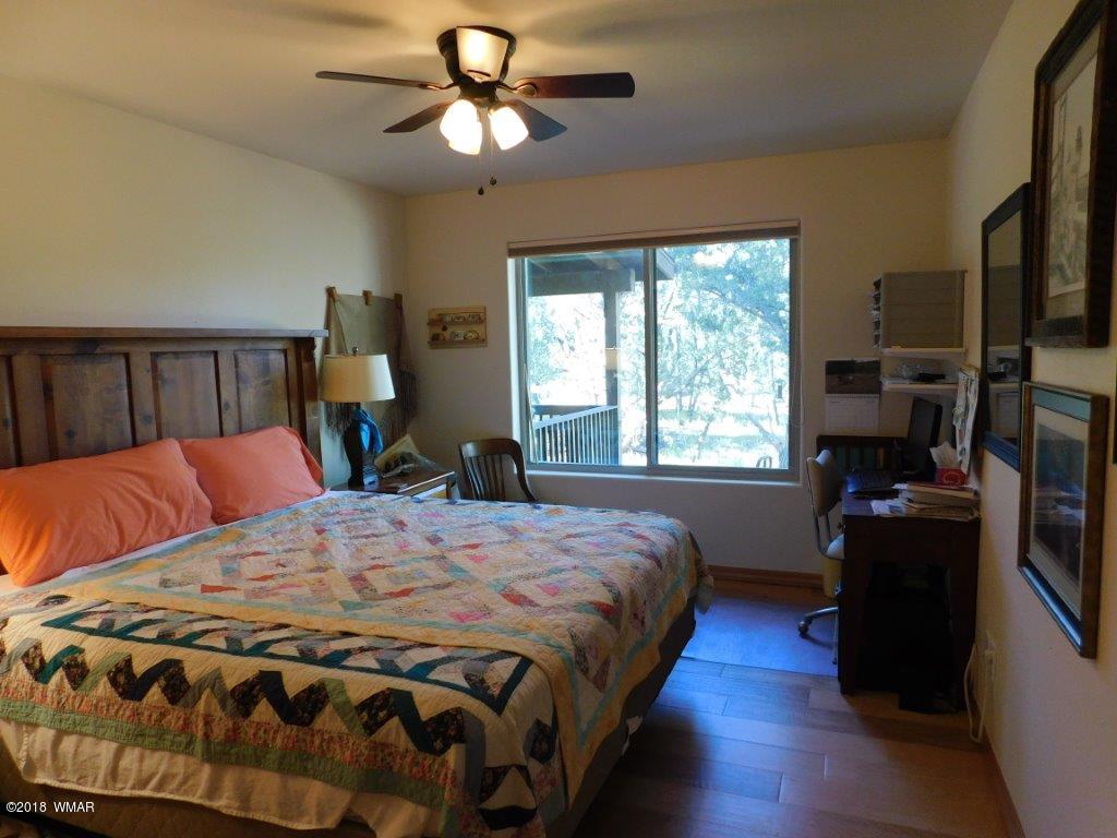 1941 Rim View Lane Heber, AZ 85928 - Photo 27 of 41 a bedroom with a bed a window and a flat screen television