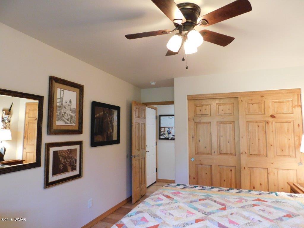 1941 Rim View Lane Heber, AZ 85928 - Photo 28 of 41 a bedroom with a bed and a chandelier