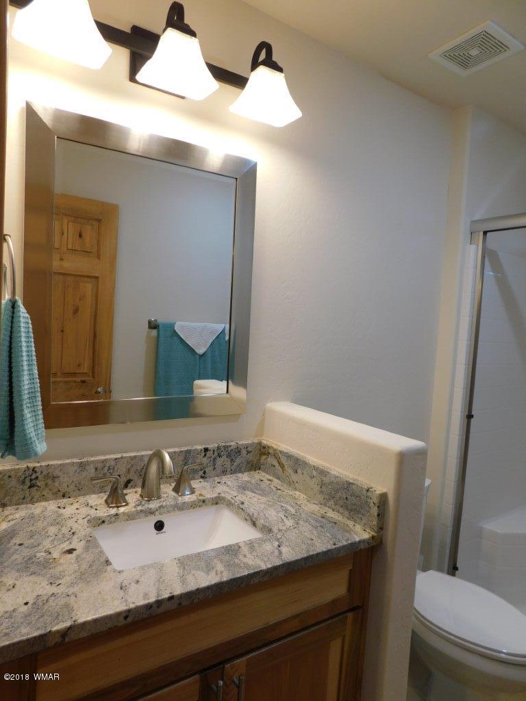 1941 Rim View Lane Heber, AZ 85928 - Photo 29 of 41 a bathroom with a granite countertop sink and a mirror