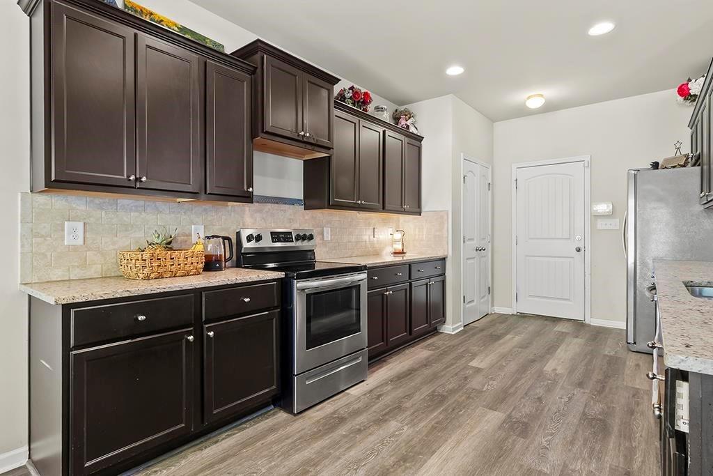 184 Amelia Drive Byron, GA 31008 - Photo 12 of 43 a kitchen with stainless steel appliances granite countertop a refrigerator a sink dishwasher a stove and a microwave oven on granite countertops
