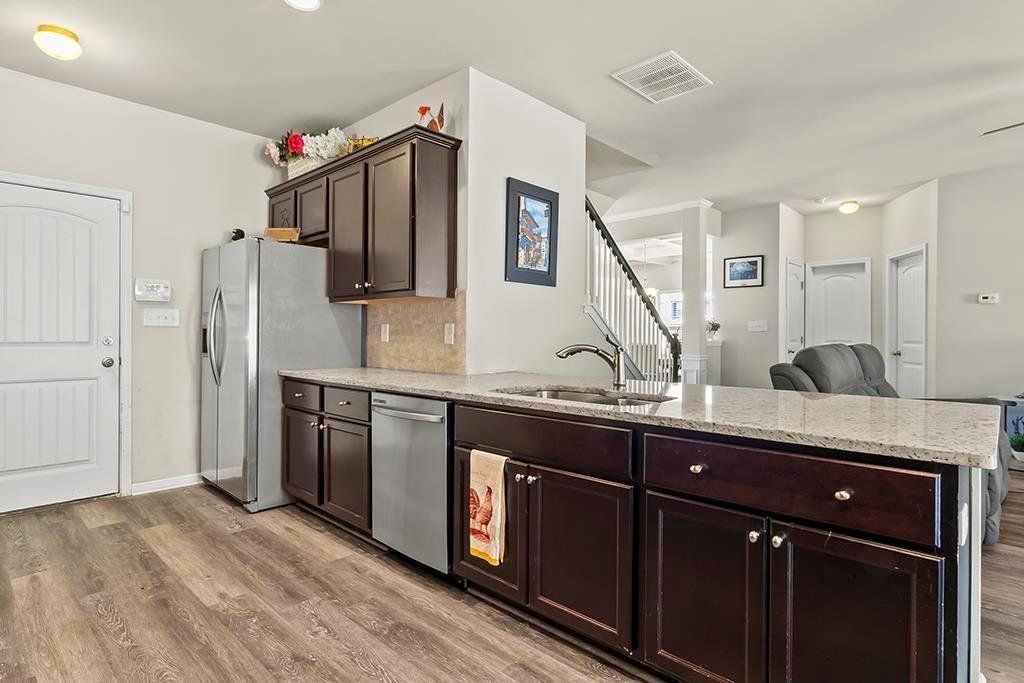 184 Amelia Drive Byron, GA 31008 - Photo 13 of 43 a kitchen with stainless steel appliances granite countertop a sink and wooden cabinets