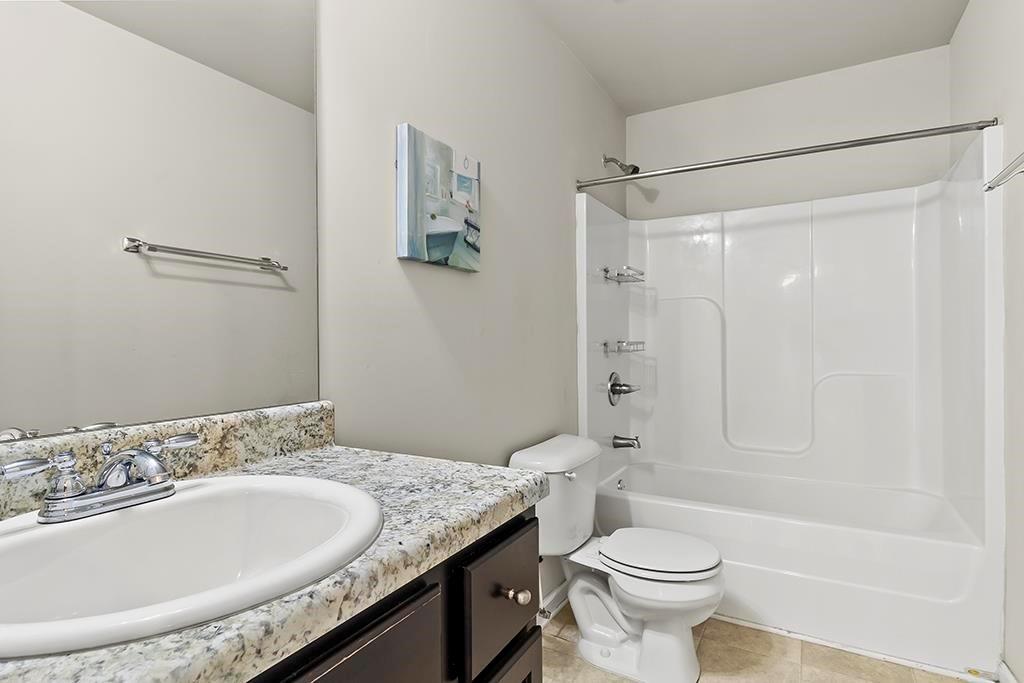 184 Amelia Drive Byron, GA 31008 - Photo 26 of 43 a bathroom with a granite countertop sink toilet and shower