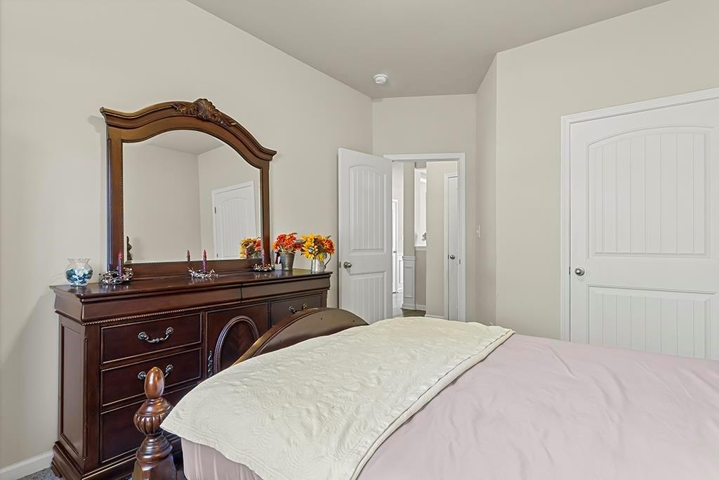 184 Amelia Drive Byron, GA 31008 - Photo 29 of 43 a bedroom with a bed and a table