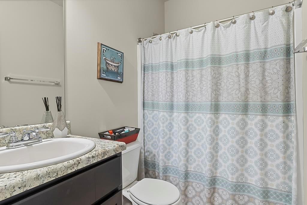 184 Amelia Drive Byron, GA 31008 - Photo 30 of 43 a bathroom with a granite countertop sink and a mirror
