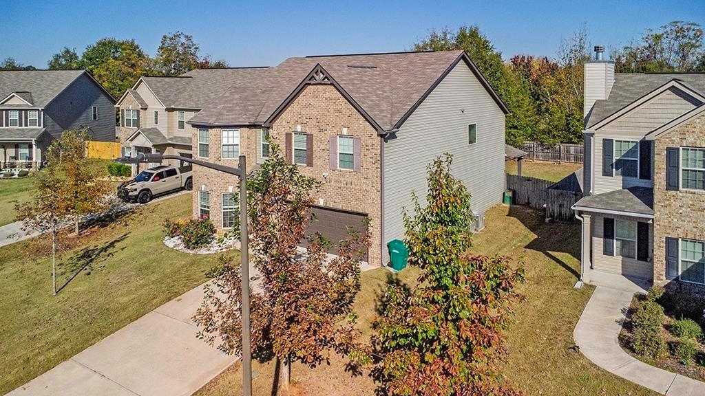 184 Amelia Drive Byron, GA 31008 - Photo 3 of 43 a view of a white house next to a yard with potted plants