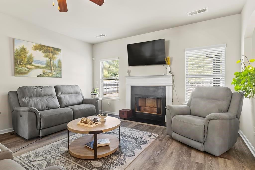 184 Amelia Drive Byron, GA 31008 - Photo 9 of 43 a living room with furniture a flat screen tv and a fireplace