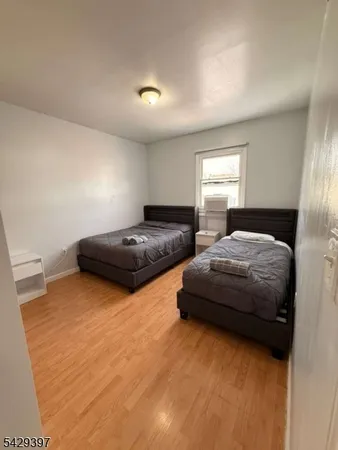 a spacious bedroom with two beds and a window