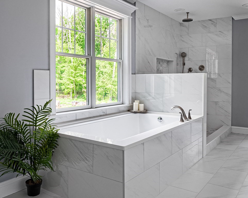 168 River Road East, Unit LOT 2 Hudson, MA 01749 - Photo 9 of 10 a bath tub sitting in a bathroom next to a window