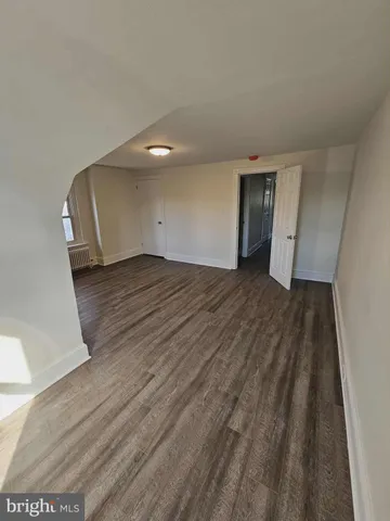 a view of an empty room and wooden floor