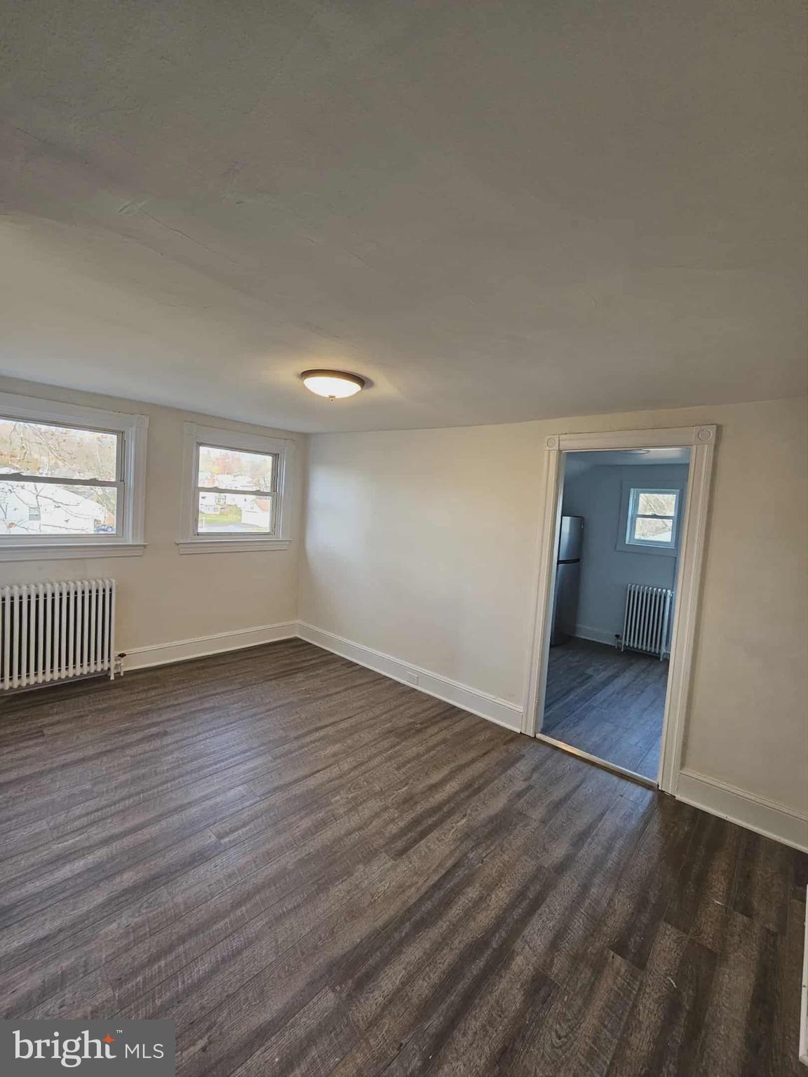 501 West Callowhill Street, Unit 7 Perkasie, PA 18944 - Photo 3 of 8 a view of an empty room with wooden floor and window