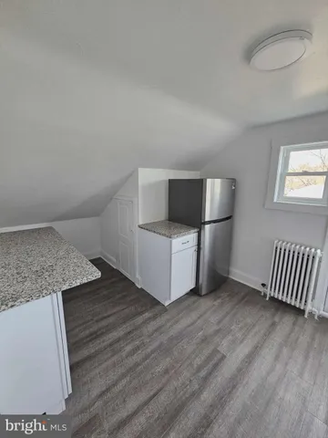 a view of an empty room and wooden floor