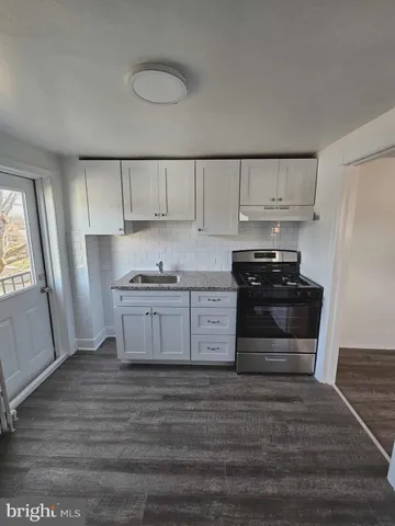 a kitchen with wooden cabinets and a stove top oven