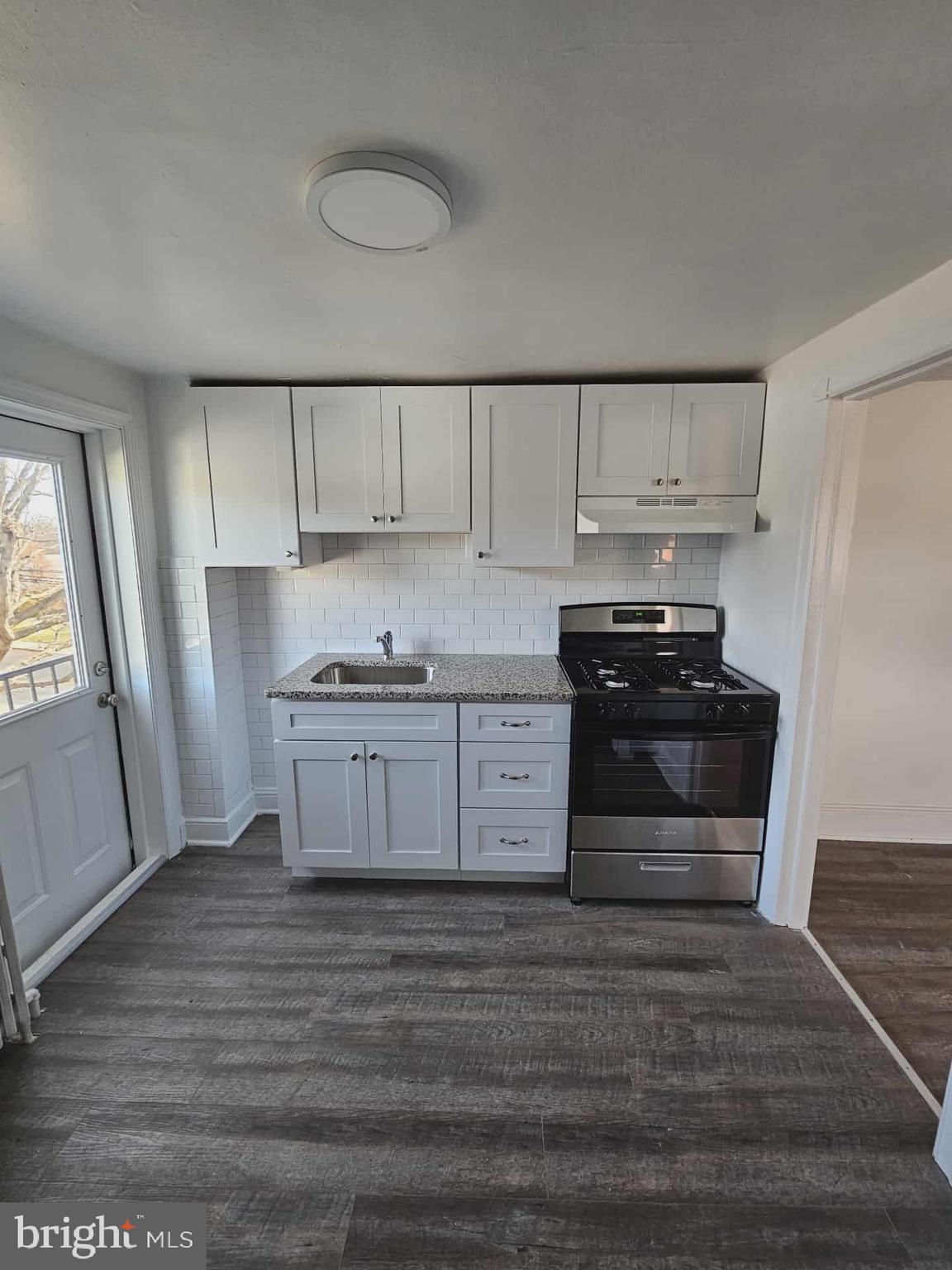 501 West Callowhill Street, Unit 7 Perkasie, PA 18944 - Photo 6 of 8 a kitchen with wooden cabinets and a stove top oven