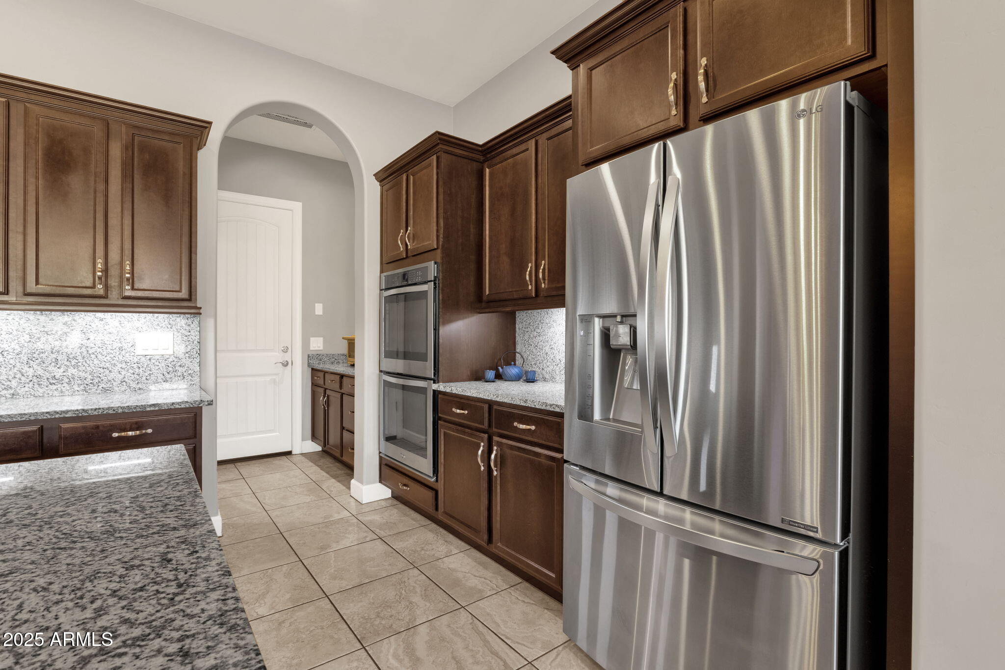 22322 East Rosa Road Queen Creek, AZ 85142 - Photo 11 of 83 a kitchen with stainless steel appliances granite countertop a refrigerator and a sink
