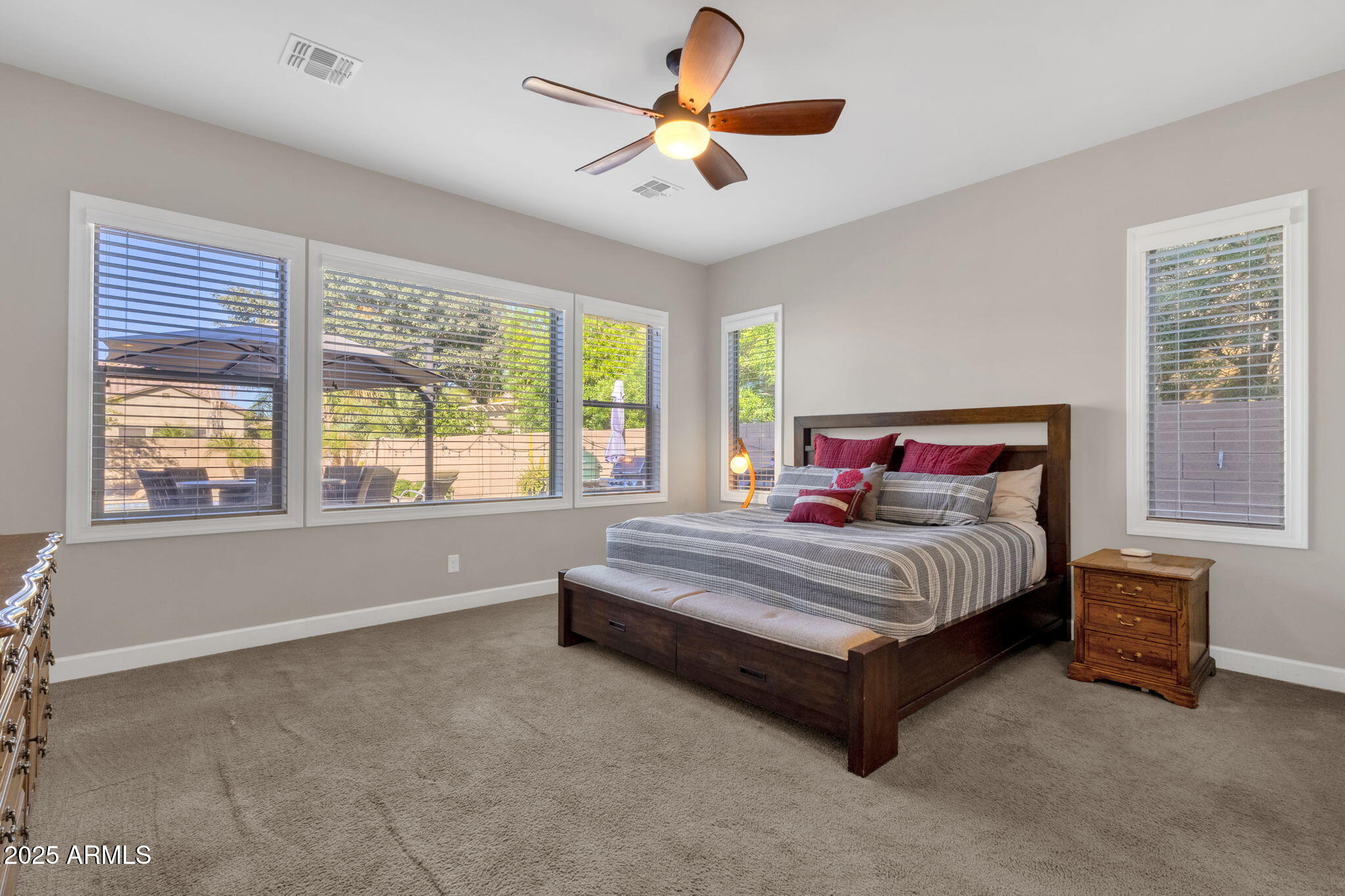 22322 East Rosa Road Queen Creek, AZ 85142 - Photo 27 of 83 a spacious bedroom with a bed and a chandelier