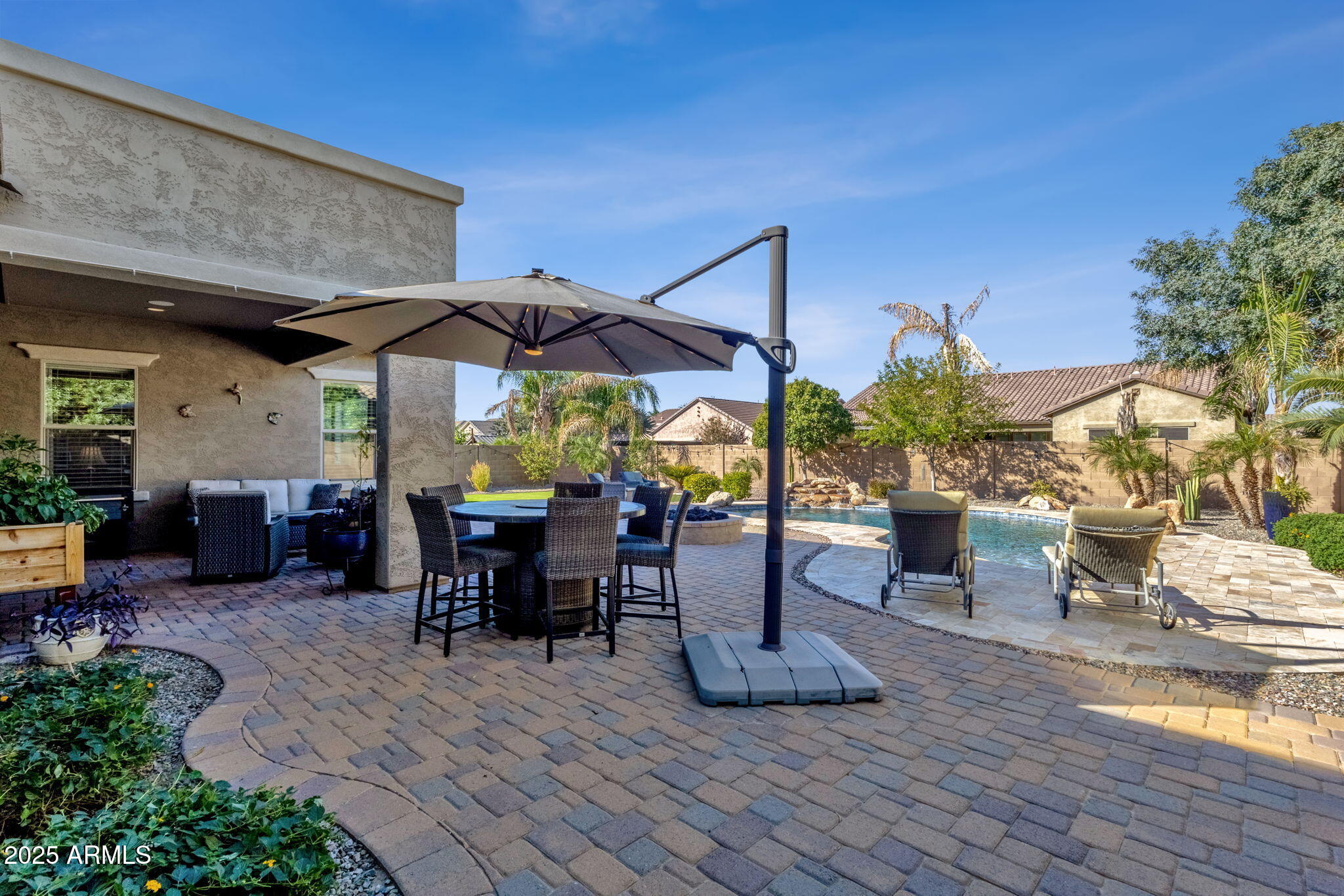 22322 East Rosa Road Queen Creek, AZ 85142 - Photo 49 of 83 a view of a patio with table and chairs under an umbrella