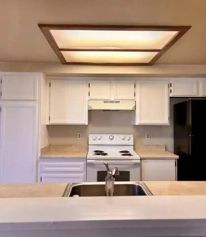 a kitchen with a stove cabinets and a counter top space