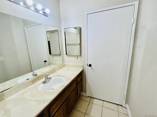 a bathroom with a double vanity sink and mirror