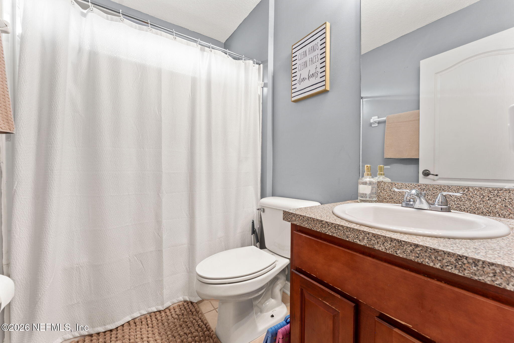 45212 Ingleham Circle Callahan, FL 32011 - Photo 17 of 35 a bathroom with a toilet a sink and a mirror