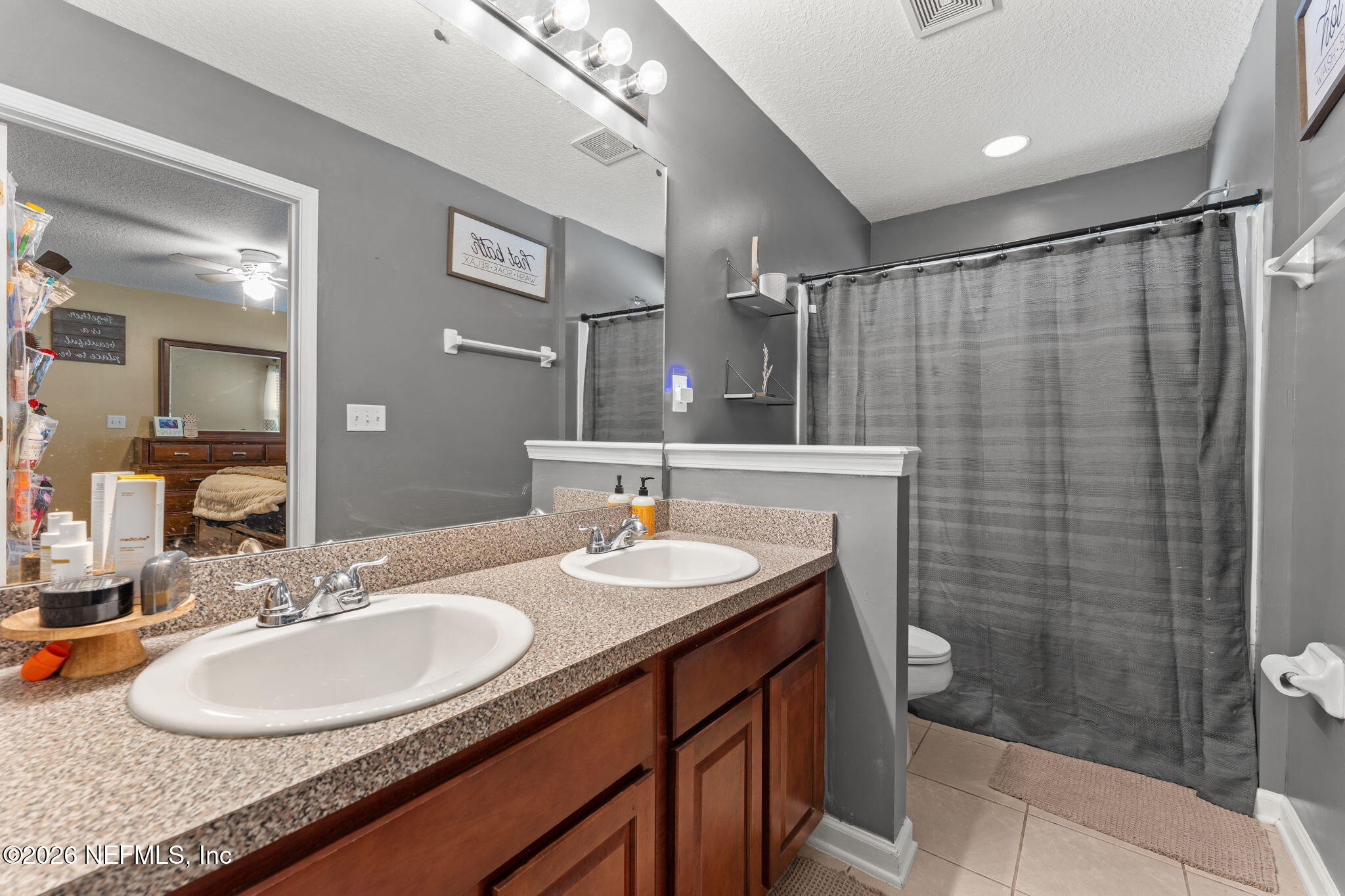 45212 Ingleham Circle Callahan, FL 32011 - Photo 34 of 35 a bathroom with a sink double vanity and a shower